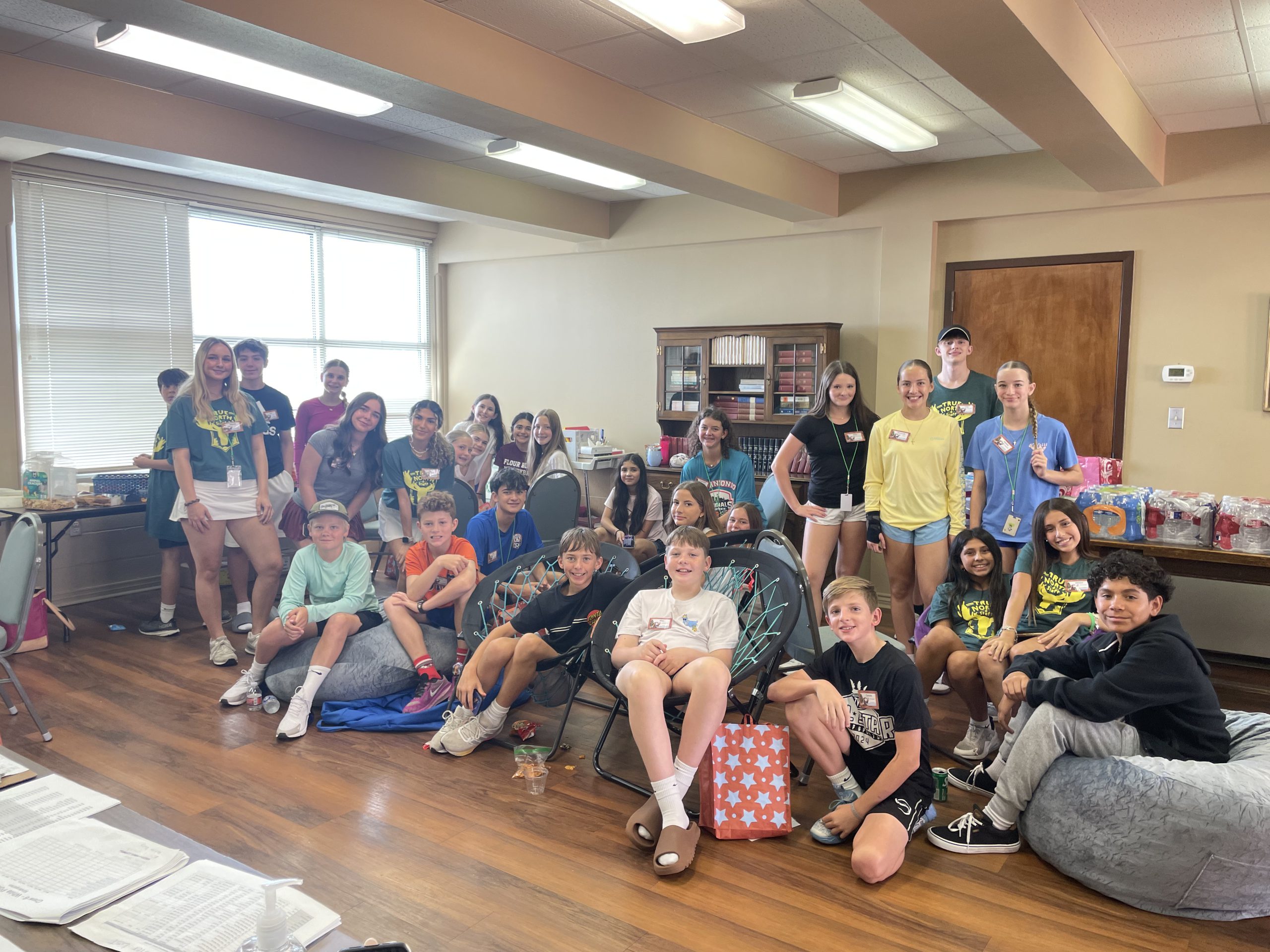 group image of teens posing in front of youth house