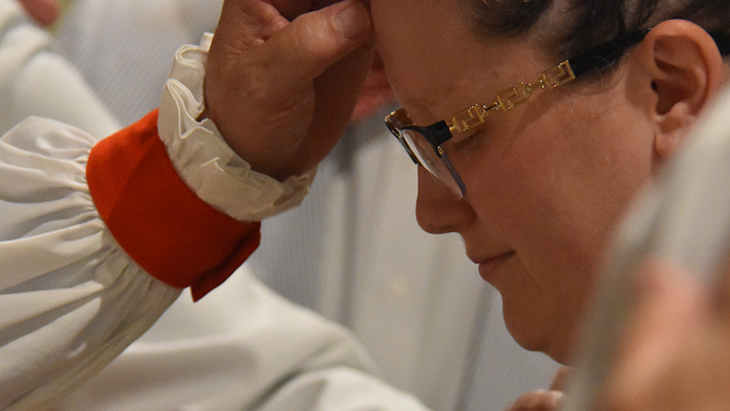 I'm New Menu photo of a minister blessing a woman